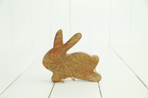 A wooden carving of a rabbit.