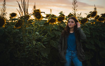 teen girl standing in a field of sunflowers