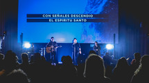 Spanish on a projection screen behind worship leaders 
