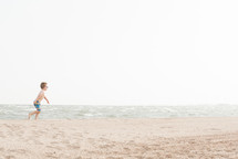 child running on a beach 