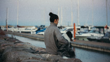 Woman with her dog at the dock