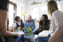 woman's group Bible study having discussions in a living room.