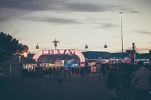 a fair midway and crowd 