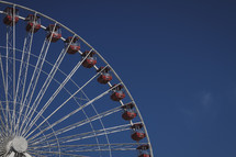 A giant ferris wheel against a blue sky.