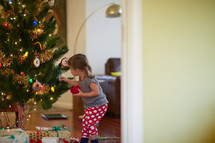 a girl decorating a Christmas tree