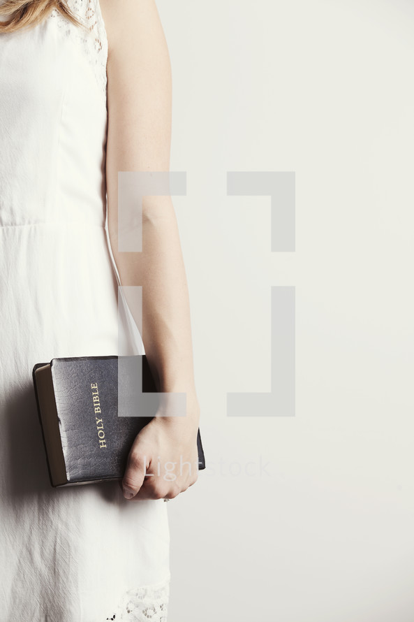Woman holding a Bible by her side.