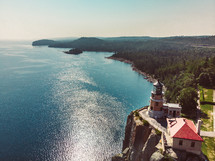 lighthouse on cliffs along a shoreline 