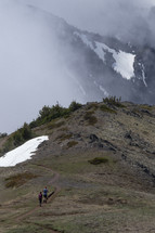 people hiking up a snowy mountaintop 