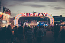 a fair midway sign at night 