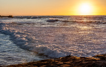 Ocean waves at sunset.