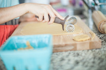 a woman cutting dough 