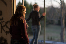 teen girls in an abandoned building at sunset 