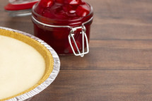 Thick Cherry Pie Filling in a Glass Canning Jar and cheesecake 