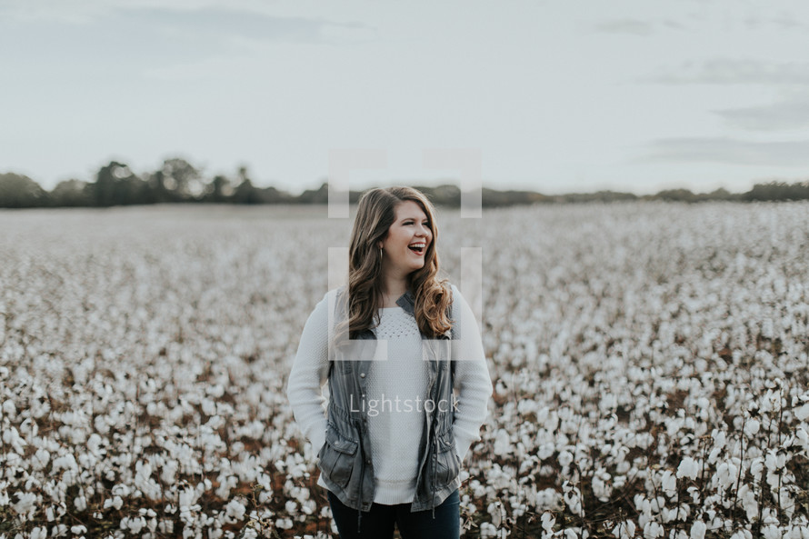 woman standing in a field of cotton 
