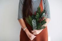 woman holding Christmas greenery 