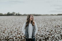 woman standing in a field of cotton 