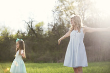 mother and daughter dancing in the sunlight 