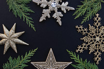 gold snowflake ornaments on a black background 