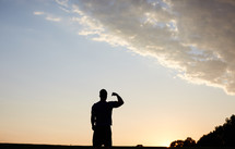 silhouette of a man showing his muscles 