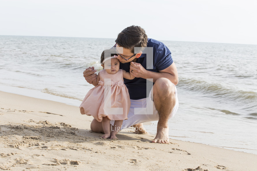 father and daughter on a beach 
