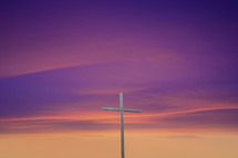 a cross against a purple sky 