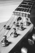 Close up from an old vintage guitar headstock , Full with dust. In black and white.