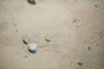 stones on the sand of a beach 