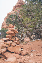 stack stones on a red clay soil 