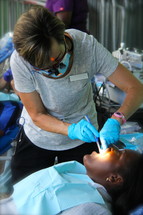 dentist looking in a child's mouth 