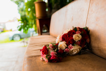 bouquet of roses on a leather bench 