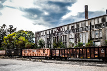 old warehouse and parked train cars 
