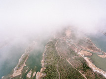 aerial view over a foggy shoreline 