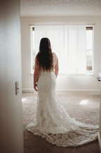 bride standing in a wedding gown 