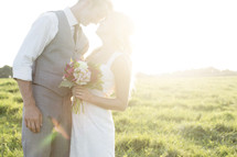 portrait of a bride and groom under intense sunlight