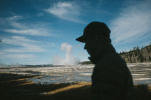 silhouette of a man near a geyser 