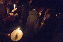 holding candles at a prayer vigil 
