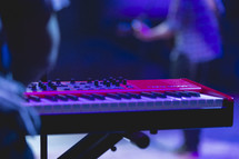 keyboard and band members at a concert 