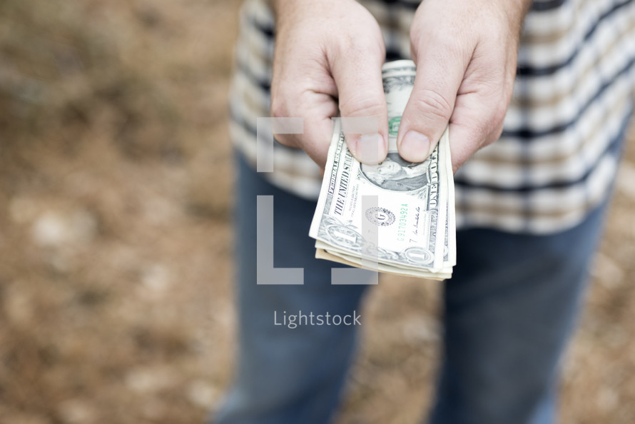 a man holding cash 