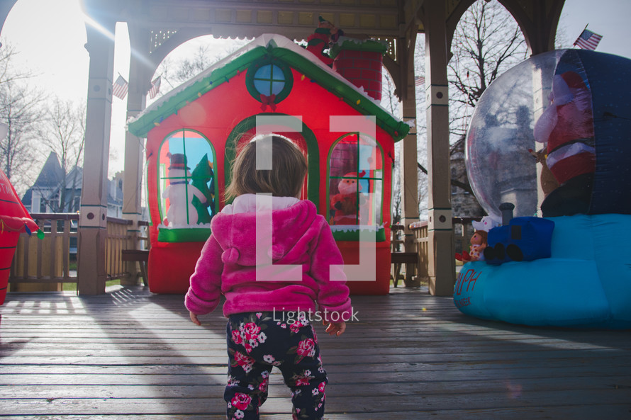 toddler looking at Christmas yard display 
