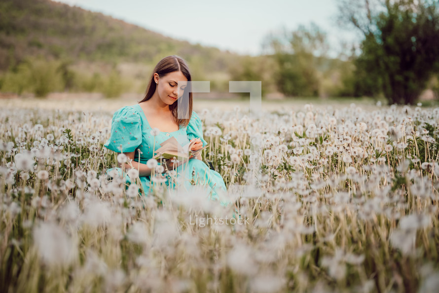Retro styled woman on fluffy dandelions field, amazing fantasy portrait. Romantic elegant lady with straw hat on nature. Vintage aesthetic lifestyle, floral background. High quality photo