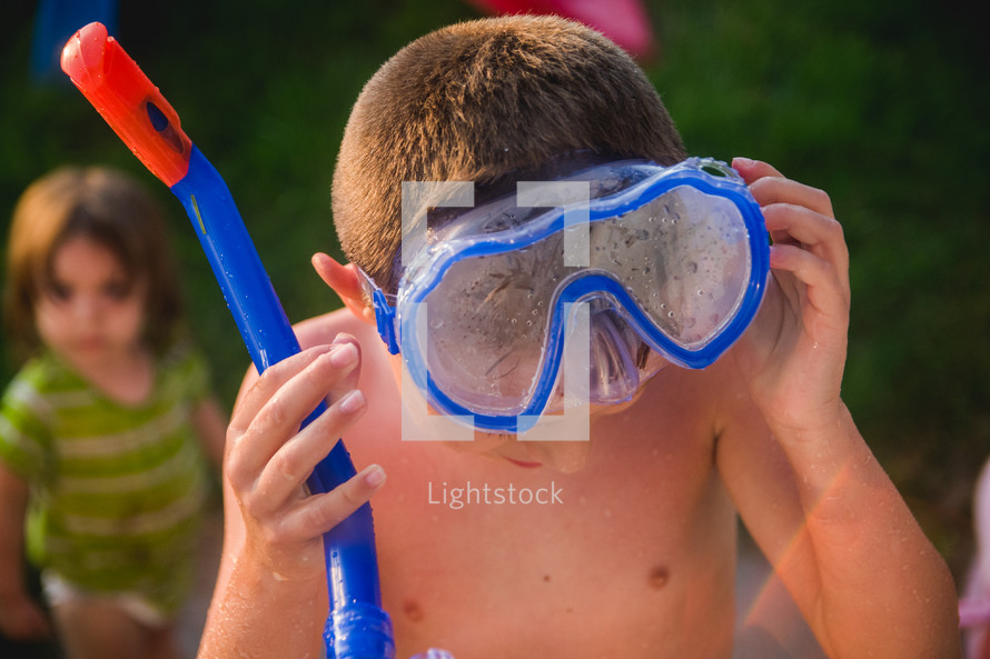 a boy with a snorkel and googles 