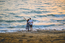 couple standing together on a beach 