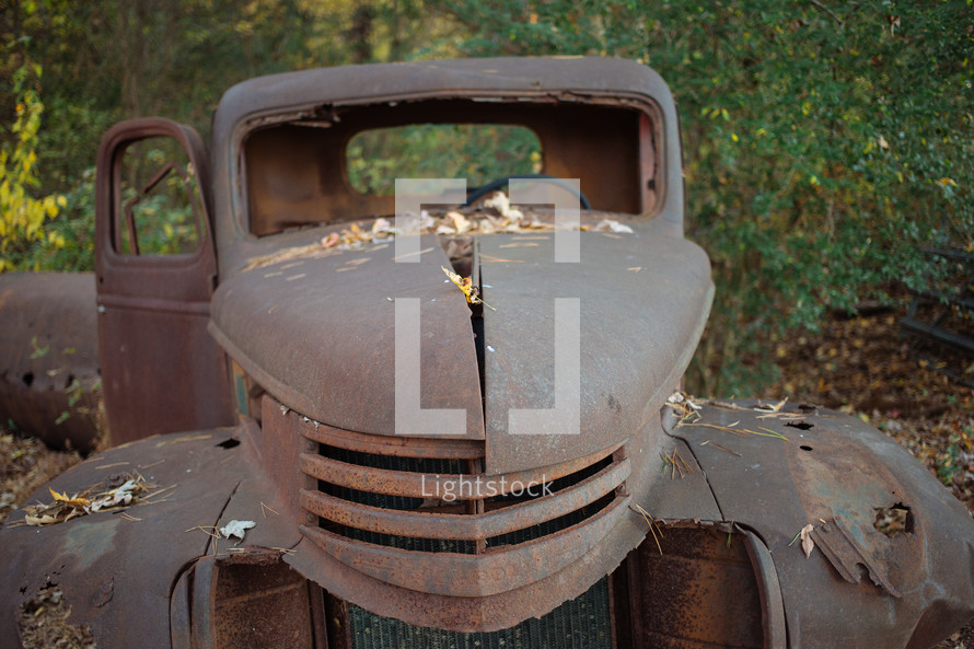 Dilapidated vintage truck outside.