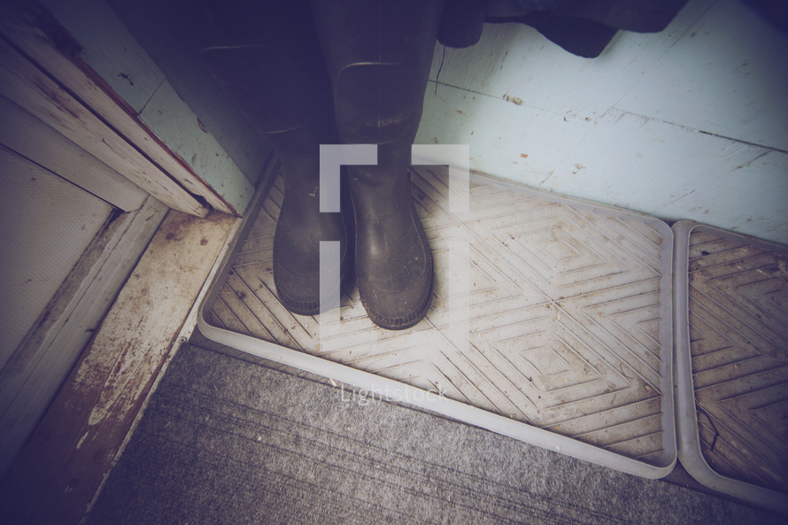 rubber boots by a doorway