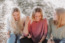three women laughing together 