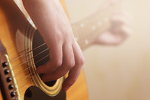 hand strumming a guitar 