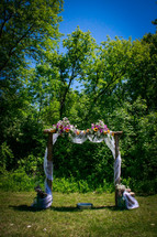 flowers on an archway for a wedding ceremony 