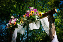 flowers on an archway for an outdoor wedding 