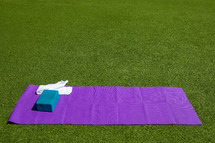 yoga mat in green grass