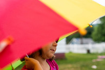 a little girl under an umbrella 
